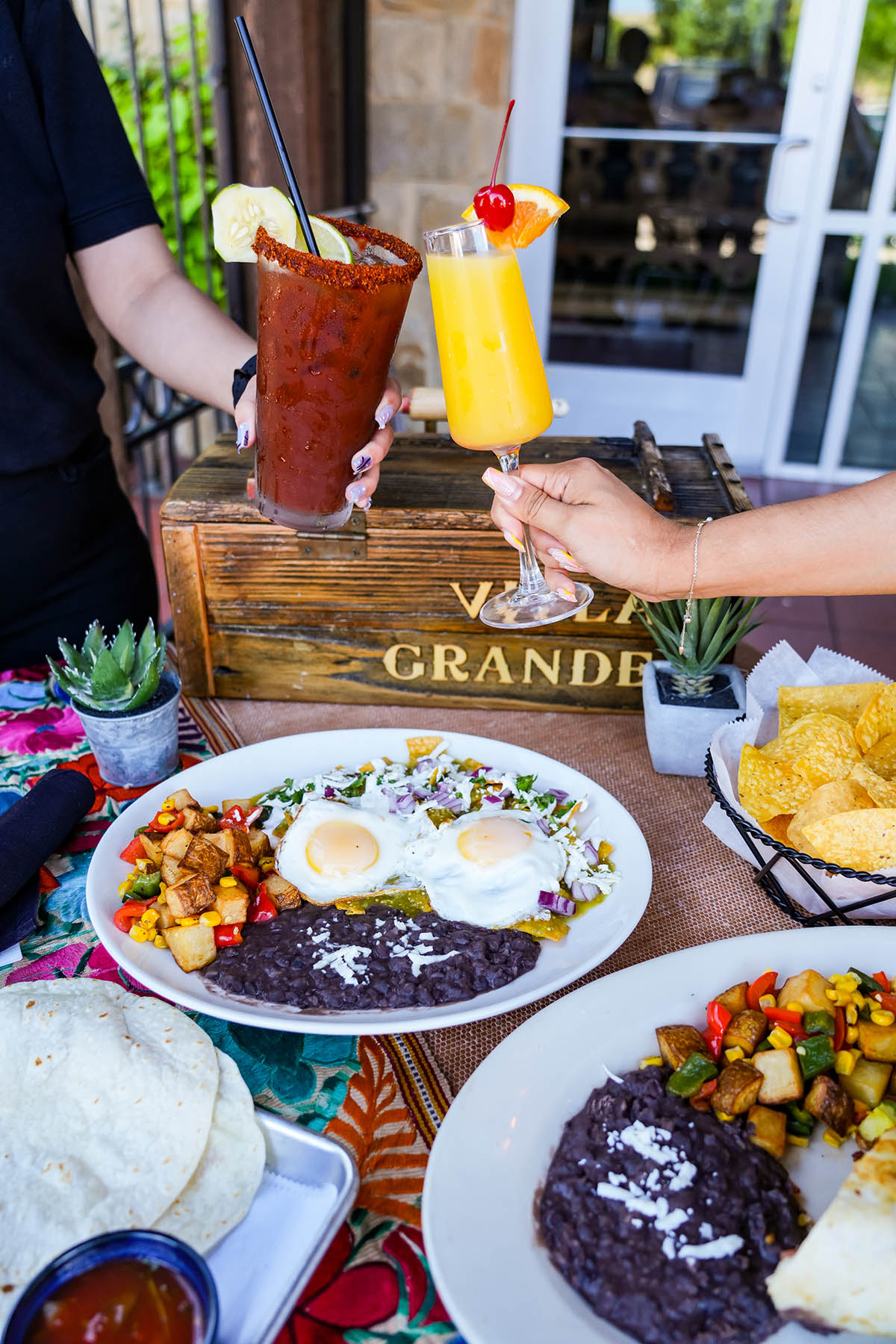 Cheering with brunch drinks